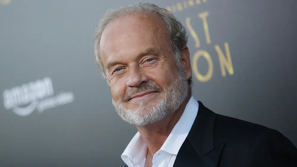 Kelsey Grammer smiling in a suit with a beard