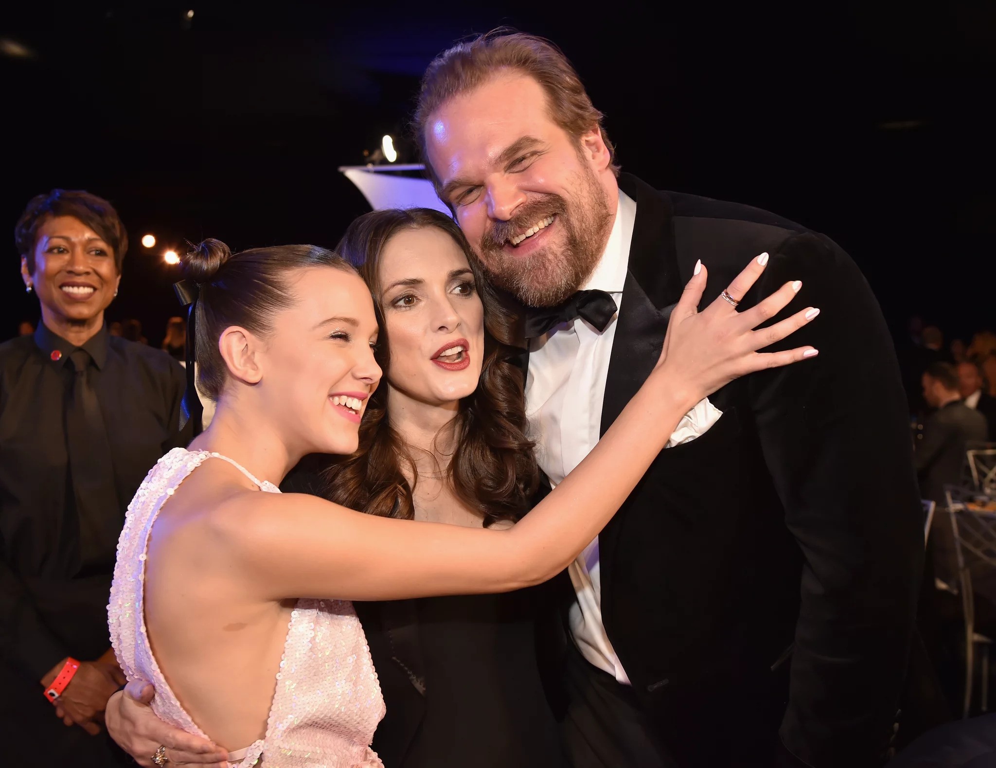 Millie Bobby Brown, Winona Ryder and David-Harbour embrace warmly at a social event