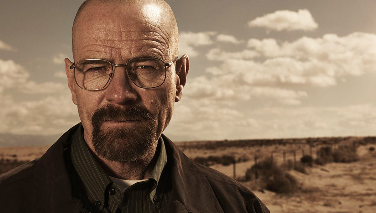 Bryan Cranston from Breaking Bad, wearing glasses and a hat in a desert landscape