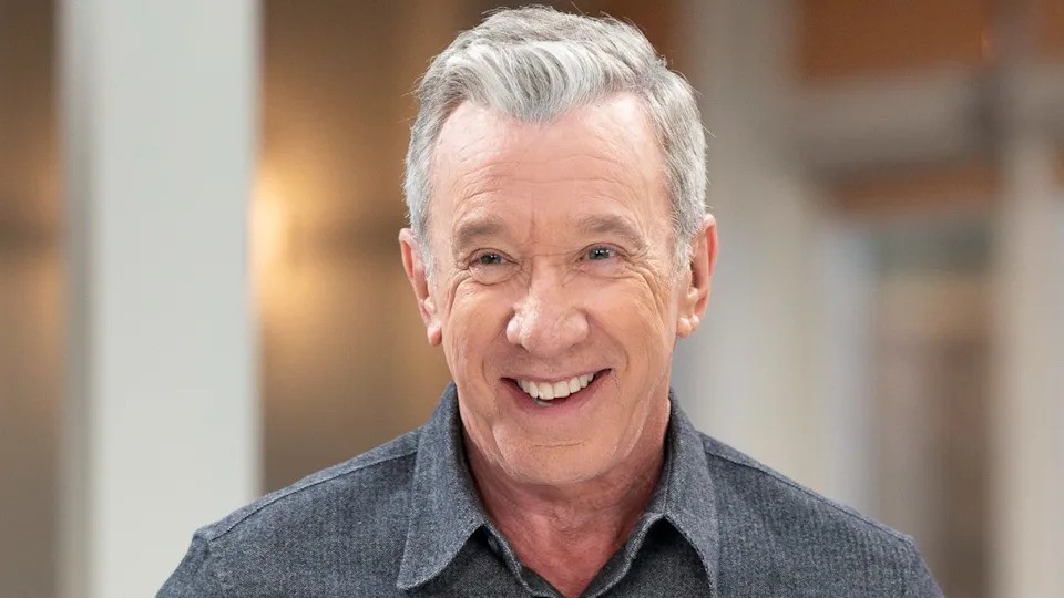 Tim Allen with gray hair wearing a black shirt
