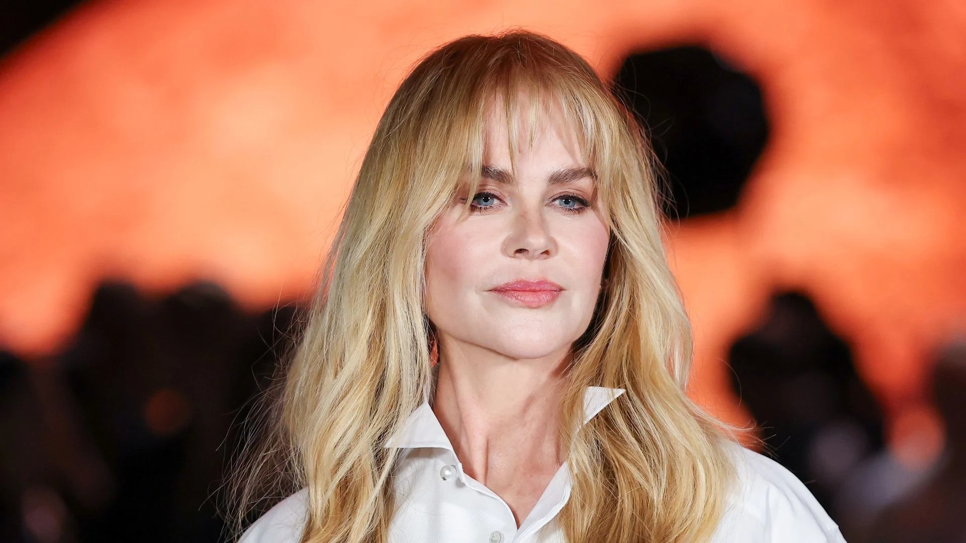 Nicole Kidman with long blond hair wearing a white shirt
